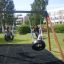 Des enfants jouent sur un Double Tyre double swing dans une aire de jeux.