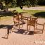 Triangle Modern Nature wooden playhouse with slide dans une aire de jeux.