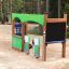 Équipement de aire de jeux pour enfants 'Gas Station' dans une zone de parc sablonneuse.