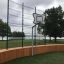 Multiarena Wooden terrain de basket extérieur avec un lac pittoresque et des arbres en arrière-plan.