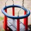 Double Swing pour enfants avec barres rouges et structure bleue.
