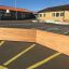 Bois Octagon Arena II installé dans une aire de jeux scolaire.