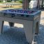 Football Table Game extérieur posé sur une surface pavée.