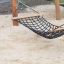 Équipement de terrain de jeu Triple Hammock sur une surface sablonneuse.