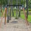 Bird Nest Single Swing (BNS 120 cm) installé dans une aire de jeux boisée.