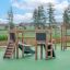 Maisonnette Mini Play II avec toboggan sur surface de jeu verte, équipement de aire de jeux en bois pour enfant