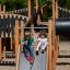 Des enfants jouent sur Windsor Modern Nature castle with slide.