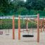 Single Swing - structure de jeu en bois avec diverses balançoires sur une surface sablonneuse