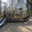 Équipement d’aire de jeux pour enfants Small Ship Nature dans un cadre forestier.