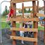 Enfants jouant sur le Sherwood wooden playhouse.