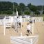 Nature Ship Sandbox, wooden playhouse dans une aire de jeux ensoleillée avec des enfants qui jouent