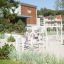 Nature Ship Sandbox, wooden playhouse dans un cadre de aire de jeux avec des enfants qui jouent.