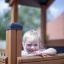 Enfant jouant dans Tower Nature wooden playhouse with slide.