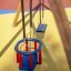 Swing Frame (double swing) dans une aire de jeux avec siège bleu et chaise de sécurité pour enfant.