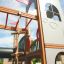 Structure en bois Camelot castle with slide pour enfants dans l’aire de jeux