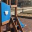 Police station playhouse with slide dans une aire de jeux