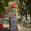 Twister castle with slide dans un parc entouré d'arbres.