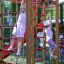 Enfants jouant sur l’équipement de aire de jeux extérieur Twister castle with slide.