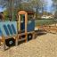Terrain de jeu en bois Tractor with trailer pour enfants.