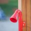 Équipement de jeu Megaphone rouge fixé à un cadre en bois.
