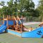 Structure de aire de jeux Small Ship with Dolphin avec accents bleus et toboggan.