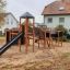 Explorer castle with slide extérieur pour enfants sur une aire de jeux.