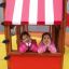 Deux filles dans un Logo Tower with Firepole playhouse with slide.