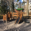Smart Modern Nature wooden playhouse with slide dans un cadre d'aire de jeux