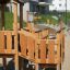 Rubik Modern Nature wooden playhouse with slide dans un parc de quartier.