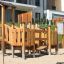 Rubik Modern Nature wooden playhouse with slide dans une aire de jeux.