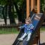 Un enfant glisse sur Logo Modern Nature playhouse with slide.