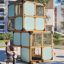 Box "Breeze" with a slide structure de jeux en bois avec panneaux bleus sur une aire de jeu sablée