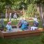 Enfants jouant dans un Sandpit sur une aire de jeux.