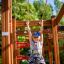 Enfant jouant sur Activity Center wooden playhouse