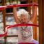 Enfant jouant sur Activity Center wooden playhouse.