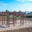 Activity Center wooden playhouse sur une aire de jeux sablonneuse